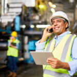 Smiling worker with radio controlling the work process
