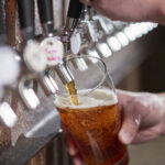 Craft beer being poured.